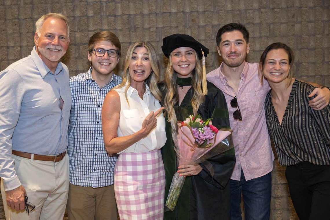UArizona College of Medicine – Phoenix graduate Claire Grayson, MD, poses for a photo with her family and friends after her class of 2022 commencement ceremony.
