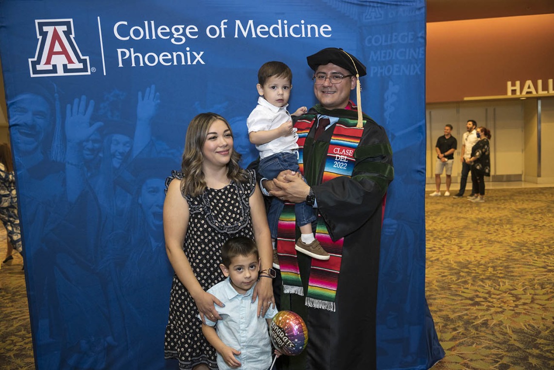 UArizona College of Medicine – Phoenix graduate Jesús Leyva, MD, poses for a photo with his wife, Fabiola, and sons Ivan and Gael after his class of 2022 commencement ceremony. 