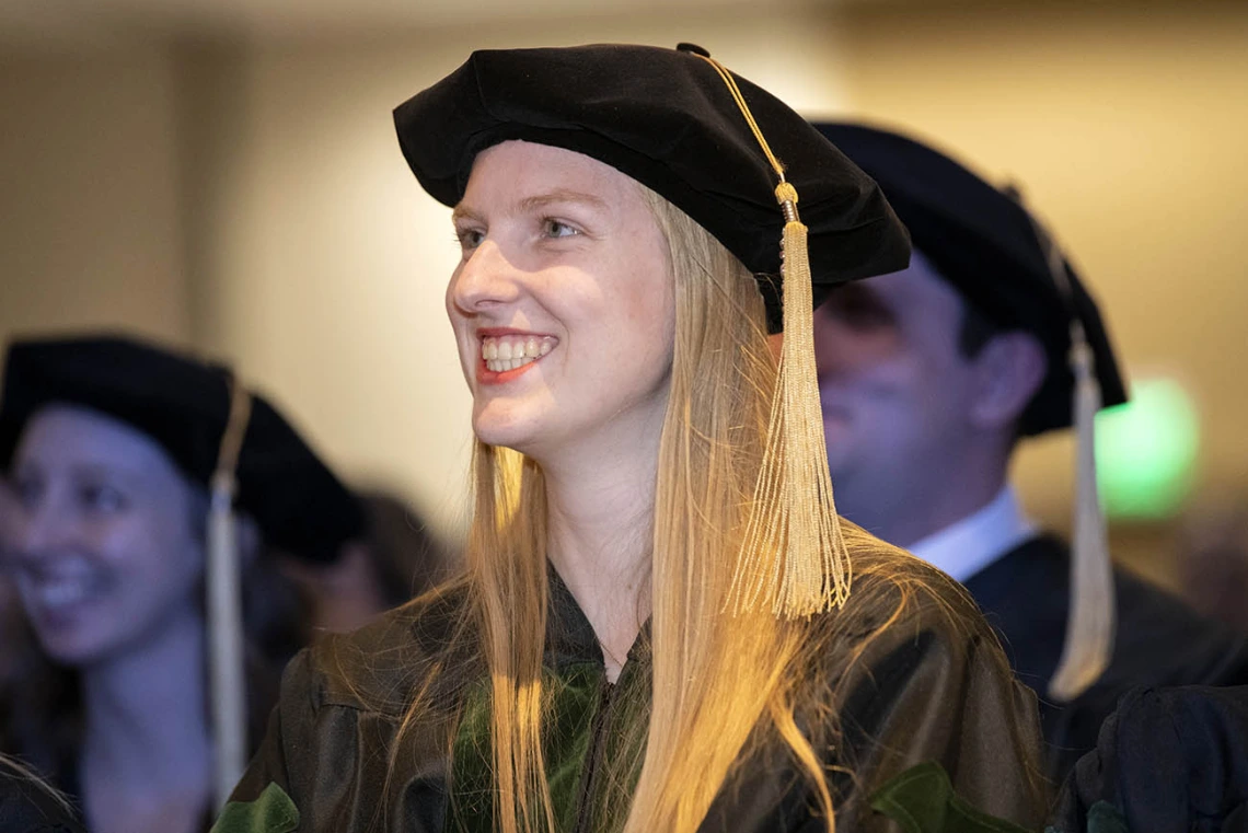 Julia Ghering, MD, is all smiles as she listens to speakers during the College of Medicine – Phoenix class of 2022 commencement ceremony.