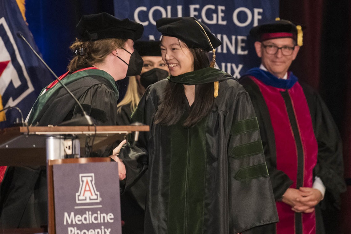 Laura Mercer, MD, MPH, MBA, (left) director, OB/GYN clerkship and director, intersessions course, congratulates Pristine Mei, MD, after she was hooded at the College of Medicine – Phoenix class of 2022 commencement ceremony.