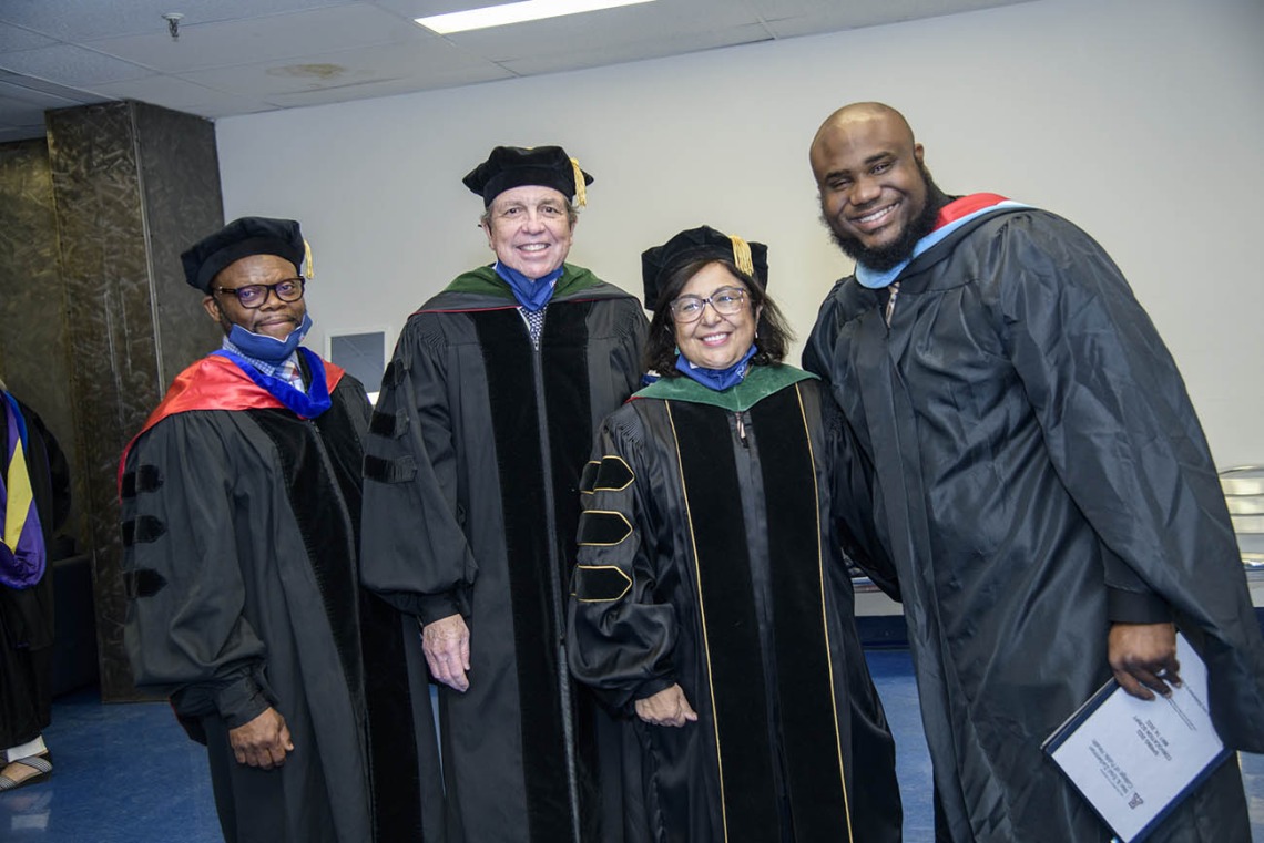 (From left) John Ehiri, PhD, MPH, MSc, associate dean for academic affairs, Michael D. Dake, MD, senior vice president of the University of Arizona Health Sciences, Dean Iman Hakim, MBBCh, PhD, MPH; and Andre Dickerson, MA, MBA, assistant dean of student services and alumni affairs, get ready to congratulate students at the Zuckerman College of Public Health convocation.  