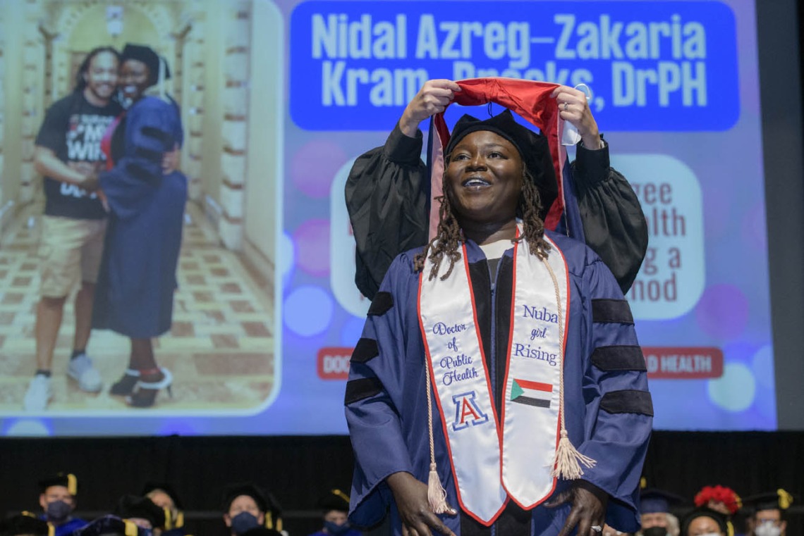 Nidal Azreg-Zakaria Kram-Brooks, DrPH, is hooded during the 2022 Mel and Enid Zuckerman College of Public Health spring convocation.