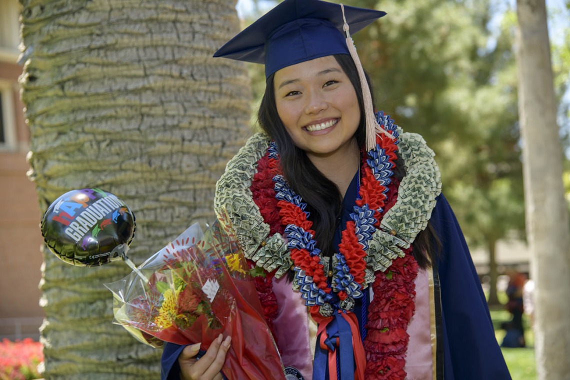 Madison Kim received her bachelor’s degree and plenty of congratulatory gifts from family and friends after the 2022 Mel and Enid Zuckerman College of Public Health spring convocation.