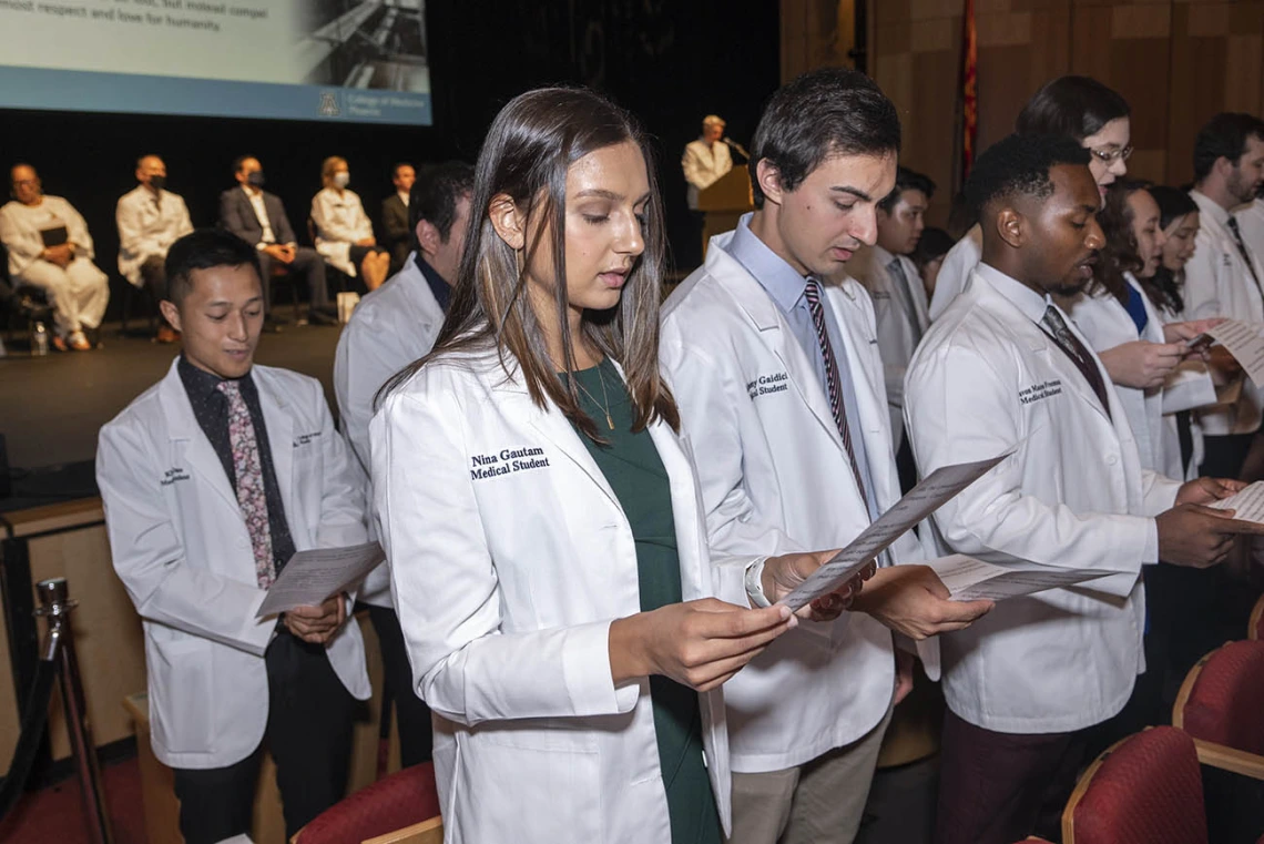 Members of the UArizona College of Medicine – Phoenix Class of 2026 recite the class oath, which they wrote together, near the end of the white coat ceremony. The class will recite the same oath at their graduation.