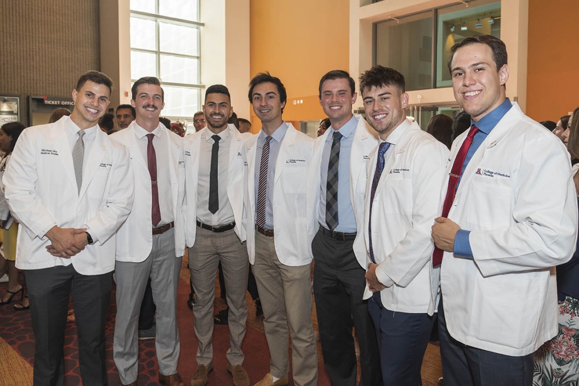 (From left) Class of 2026 students Michael Ruta, Wyatt Koolmees, Michael Mazarei, Tony Gaidici, Jackson Woodrow, Trevin Reyes and Santiago Robledo Logan-Baca pose for a photo in the lobby of Symphony Hall in downtown Phoenix after the white coat ceremony.