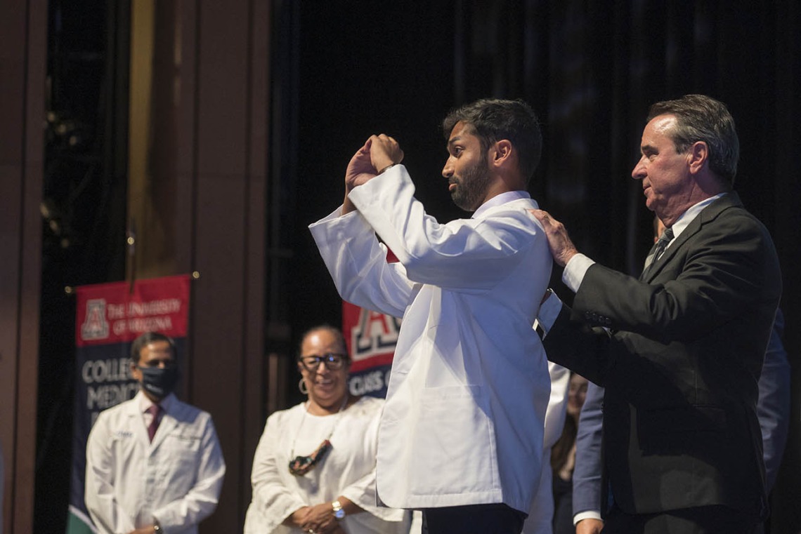 Owais Ahmed Salahudeen makes a heart symbol with his hands after donning his white coat at the UArizona College of Medicine – Phoenix Class of 2026 white coat ceremony.