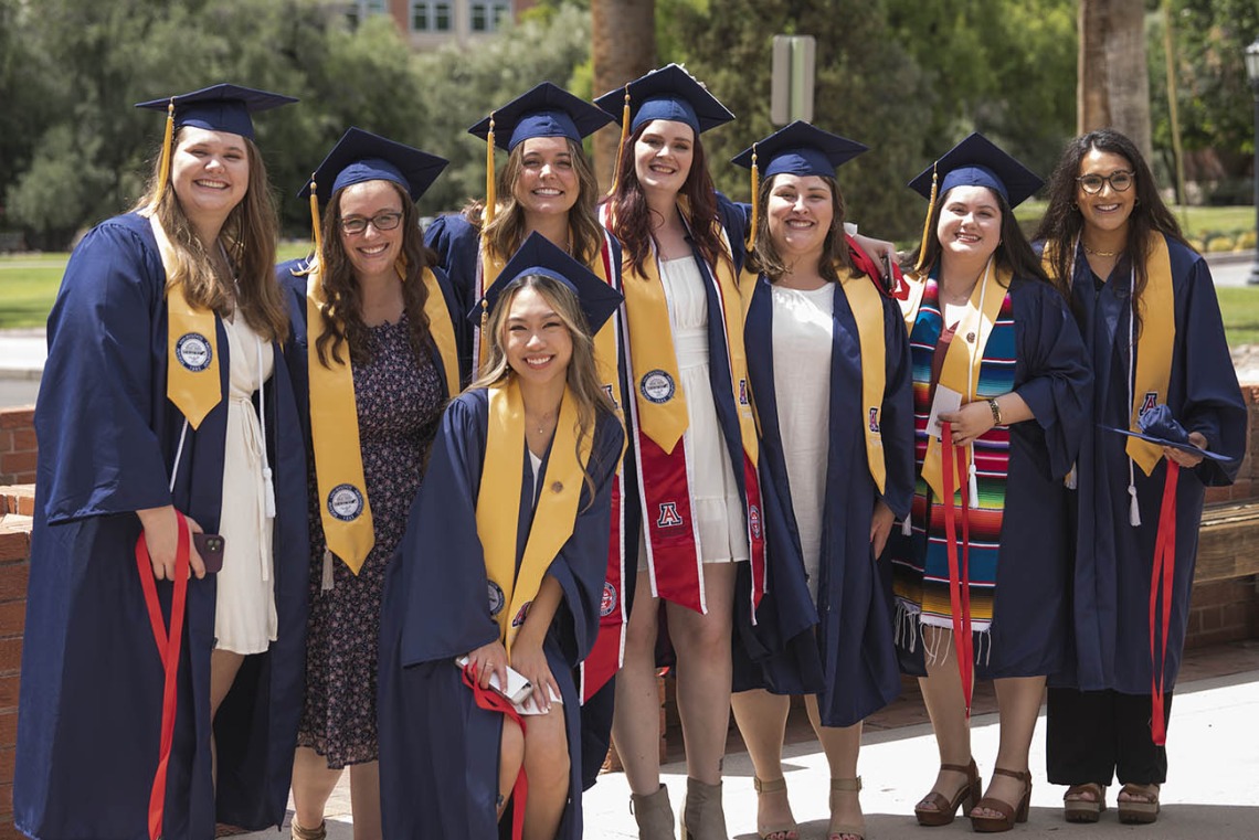 College of Nursing 2022 summer graduates from the Bachelor of Science in Nursing Integrative Health Pathway program gather for a photo outside of Centennial Hall.