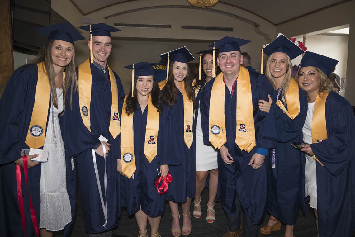 Bachelor of Science in Nursing Integrative Health Pathway graduates pause for a photo in the lobby of Centennial Hall during the College of Nursing’s 2022 summer convocation.