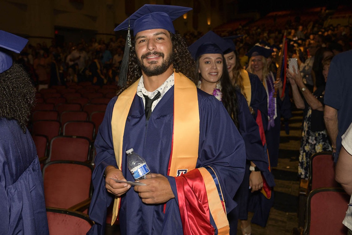 Master of Science in Nursing Entry to the Profession student Daniel Thews enters Centennial Hall with his classmates at the start of the UArizona College of Nursing summer convocation ceremony.