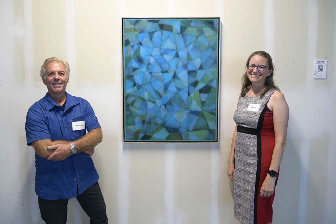 Artist Mark Pomilio and Taben Hale, PhD, an associate professor in the College of Medicine – Phoenix, stands next to the painting “Tissue Study I” during the VIP opening of the Artist + Researcher project. 