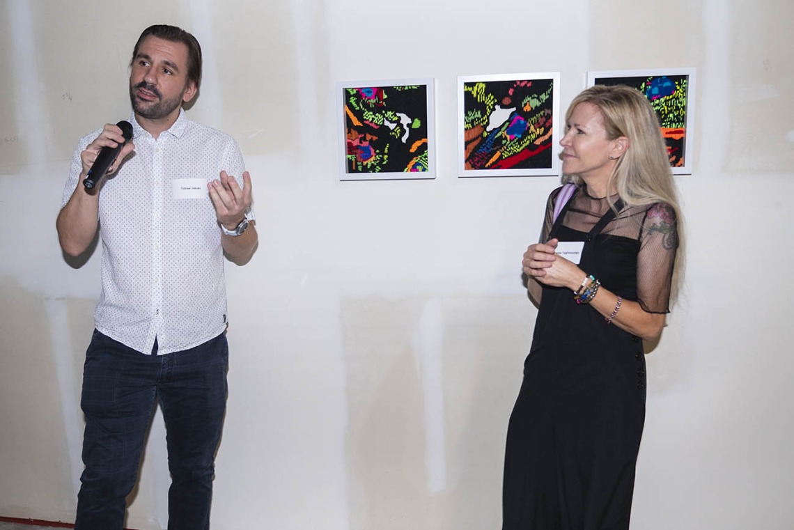 (From left) Tobias Jakobi, PhD, an assistant professor in the College of Medicine – Phoenix, talks about his experience collaborating with artist Denise Yaghmorian on “Layers of Cardiac Fibers” during the Artist + Researcher VIP exhibition opening on the Phoenix Bioscience Core.