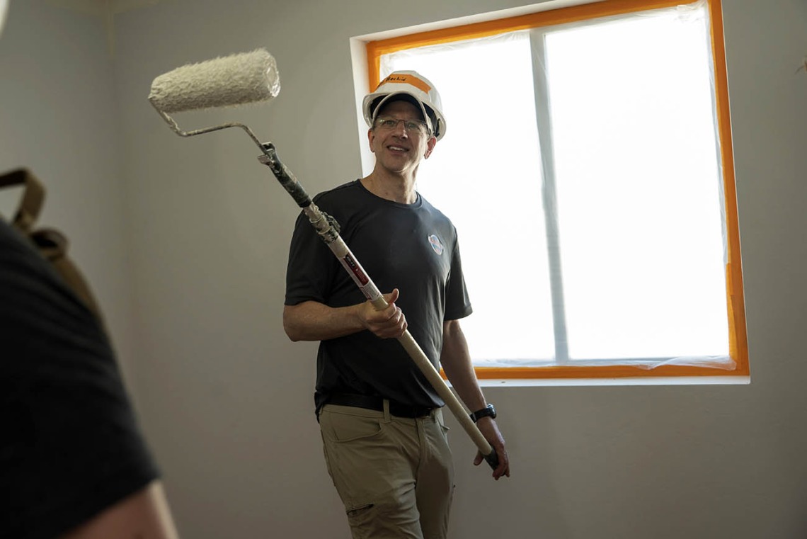 Daniel Beskind, MD, MPH, FACEP, an associate professor in the College of Medicine – Tucson’s Department of Emergency Medicine, takes a break from painting the ceiling of a Habitat for Humanity house during the EM Day of Service.  