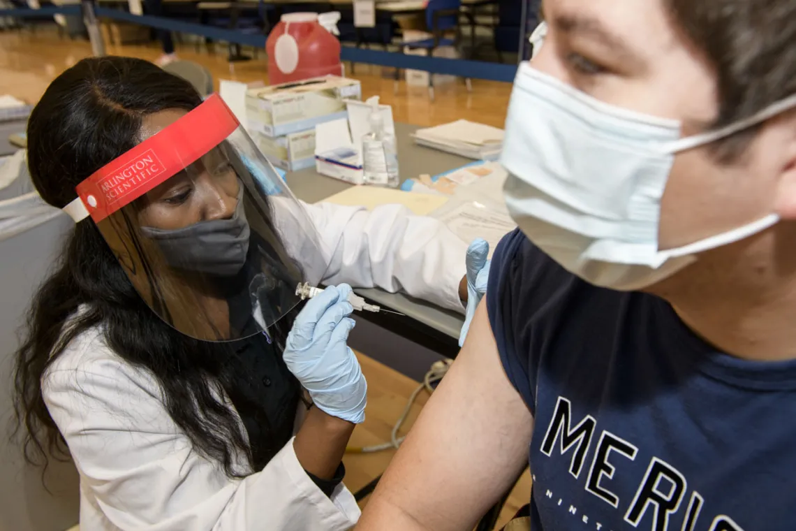 College of Pharmacy student Judy Mburu administers a flu vaccination to a student, hoping to create a comfortable environment to help patients feel at ease. “When you, as the immunizer, get comfortable, the patient will also get comfortable,” Mburu says “They’re not going to feel afraid or worried.”