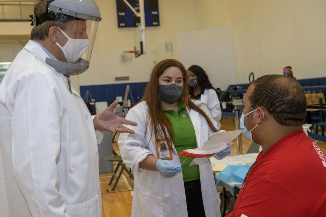 UArizona student Justin Clark learns about the flu vaccination with preceptor Michael Katz, PharmD, professor of pharmacy practice and science, and PharmD student Sammy Zimmerman.