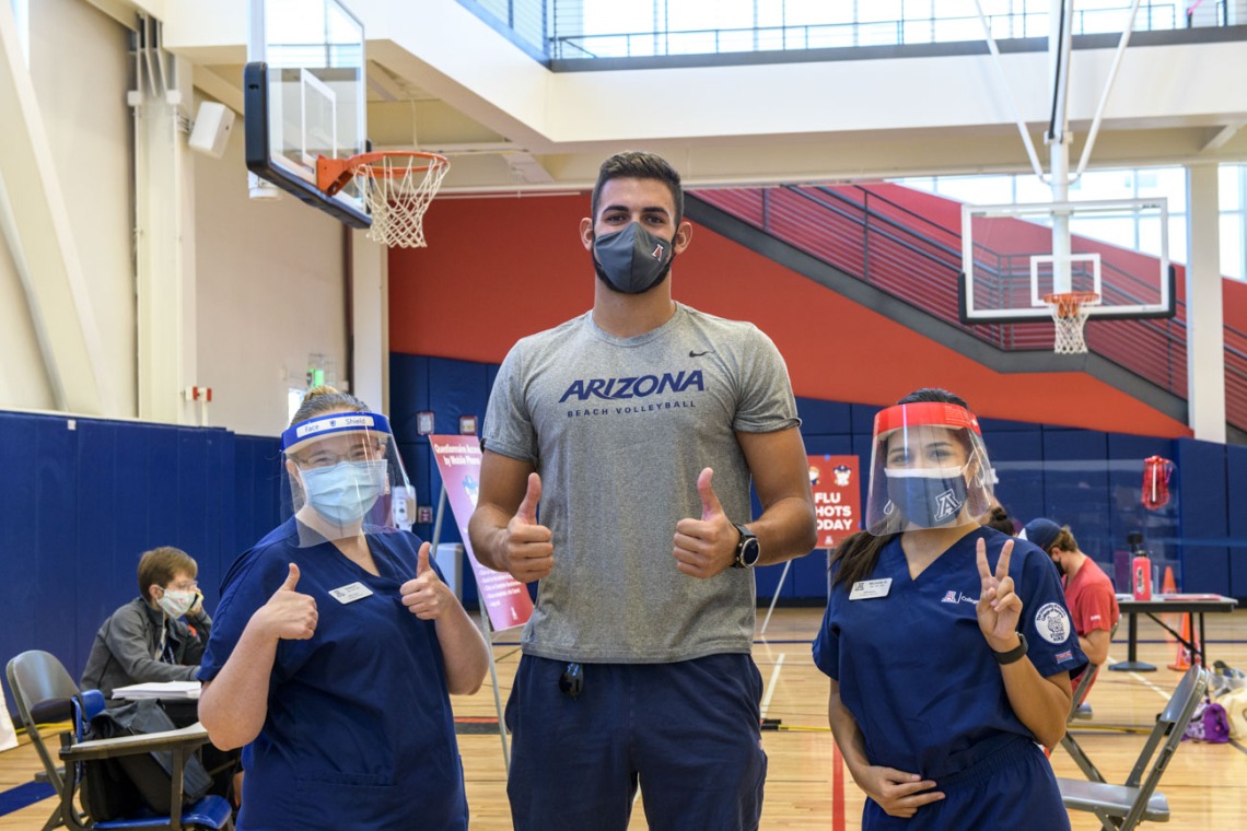 Hailey Finn and Michelle Garcia, members of the College of Nursing Master’s Entry to the Profession of Nursing (MEPN) program, pose for a photo with Chase Jones, a member of the UArizona men’s indoor volleyball club and an undergraduate student in psychology and criminal justice.