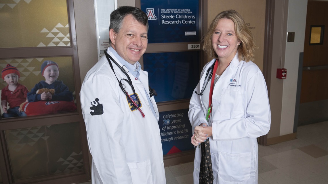 Michael Daines, MD, and Cori Daines, MD, outside the Steele Children’s Research Center, where the husband and wife have made their careers as pediatric physician-scientists since 2007.