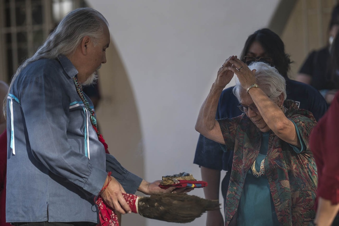 Carlos Gonzales, MD, performs a smudging ceremony, where he blesses each person with the smoke of the sacred cleansing and blessing herbs, which is burned in an abalone shell.