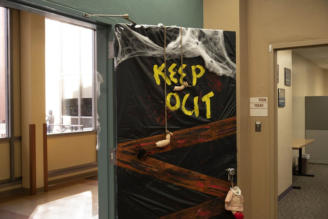 Given the state of the doll parts hanging on the door to the College of Nursing’s Office of Student and Academic Affairs, it might be best to heed the warning and keep out this Halloween. 