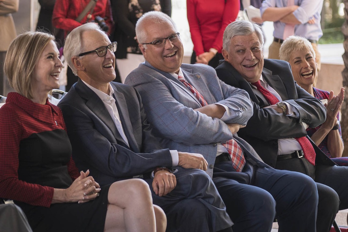 VIPs at the ceremony announcing the $50 million gift and naming of the R. Ken Coit College of Pharmacy laugh as UArizona President Dr. Robbins jokes during his speech.  