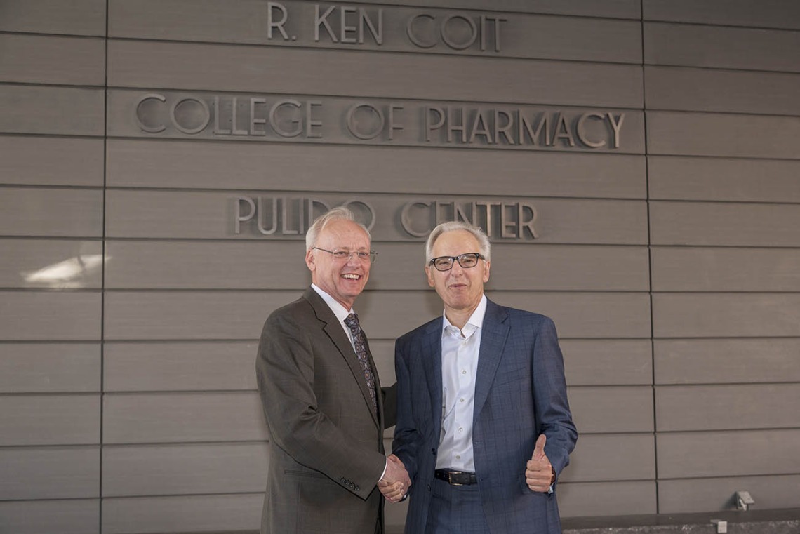 College of Pharmacy Dean Dr. Rick G. Schnellmann, left, thanks R. Ken Coit for his $50 million gift to the newly named R. Ken Coit College of Pharmacy after the unveiling ceremony. “I’ve been smiling for a week,” said Dr. Schnellmann.