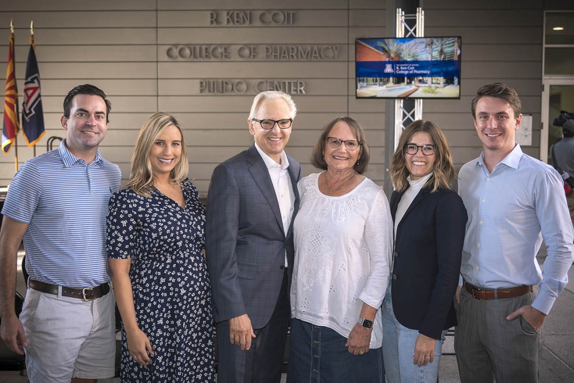 From left, Shyler Ackley, Lauryn Coit Ackley, R. Ken Coit, Donna Coit, Shannon Coit and Colin Michel pose for a family photo under the newly-unveiled signage for the R. Ken Coit College of Pharmacy. 