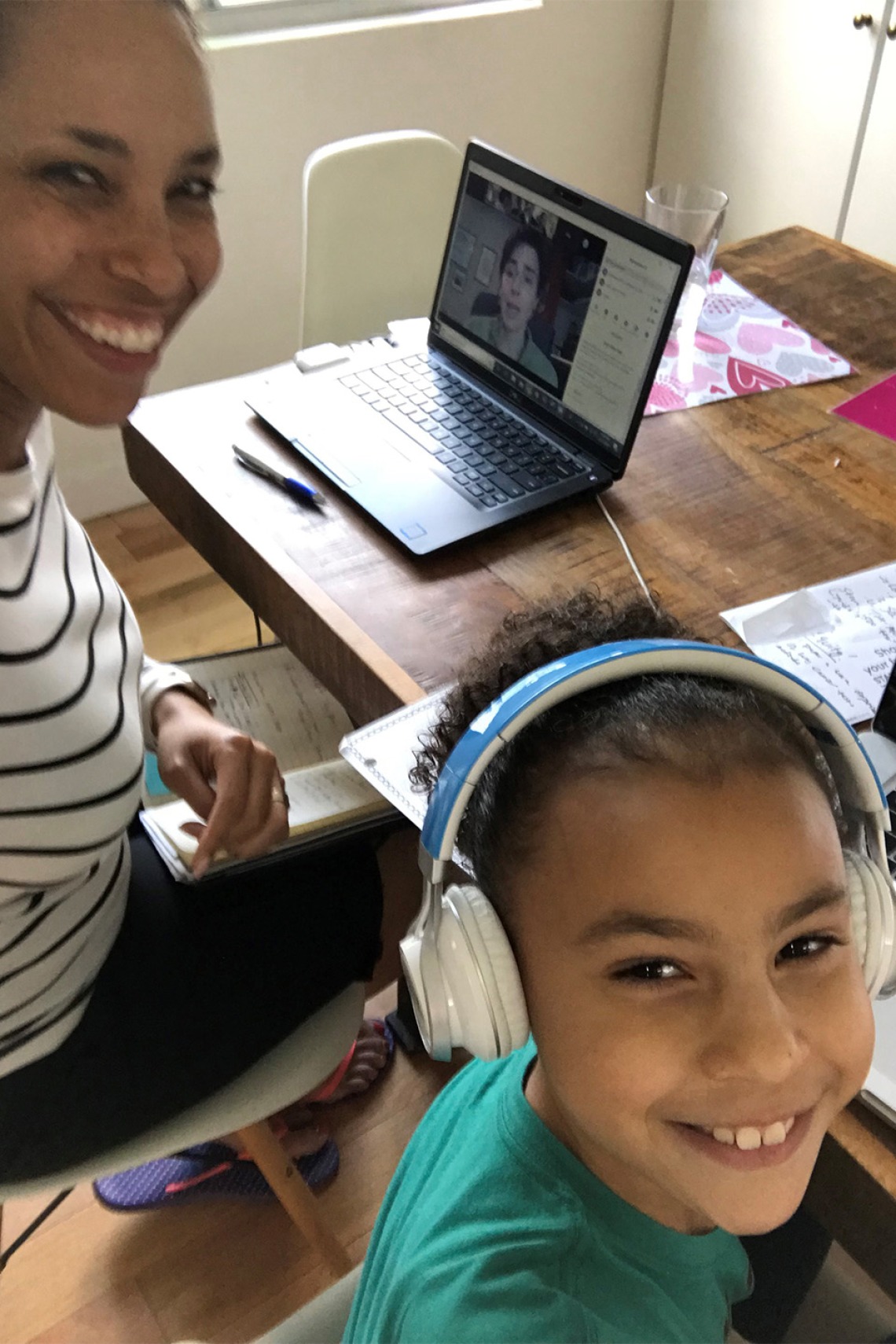 Allison Otu, executive director of corporate and community relations, poses for a photo with her daughter while working from home.