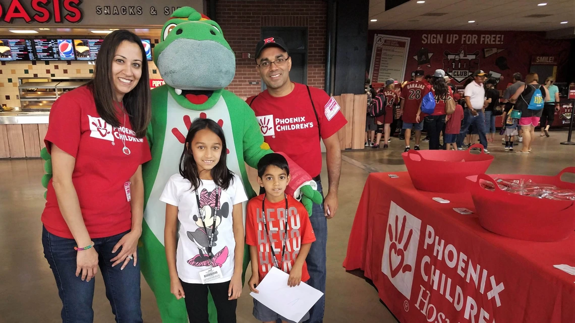 Dr. Rastogi and family at a Diamondbacks game volunteering for Phoenix Children's Hospital