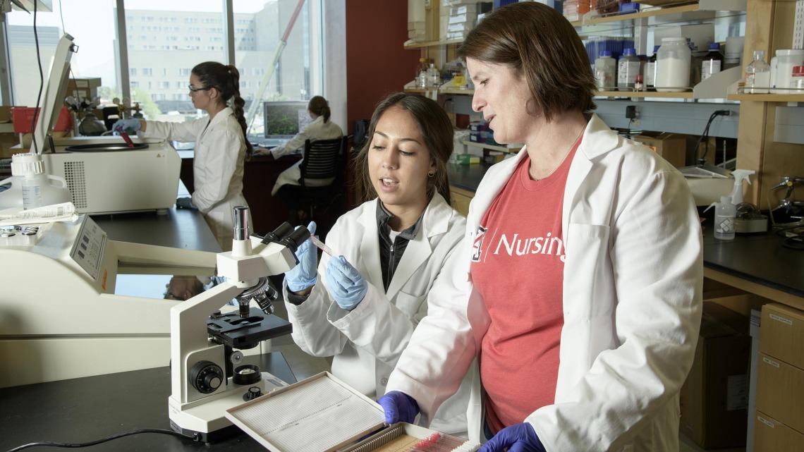 Helena W Morrison, PhD, RN, associate professor of nursing, works with a lab assistant in 2018.