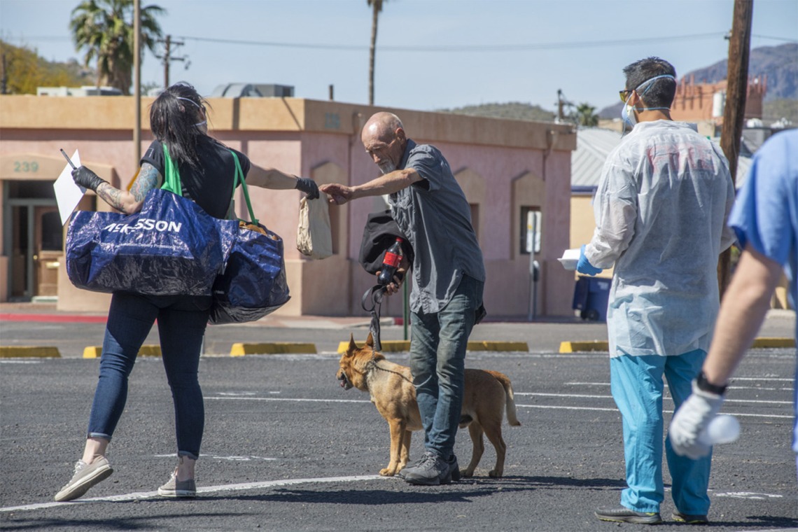 Christian Bergman, left, is a medical student volunteering to serve the homeless population of Tucson with medical services during the worldwide pandemic COVID-19 outbreak.