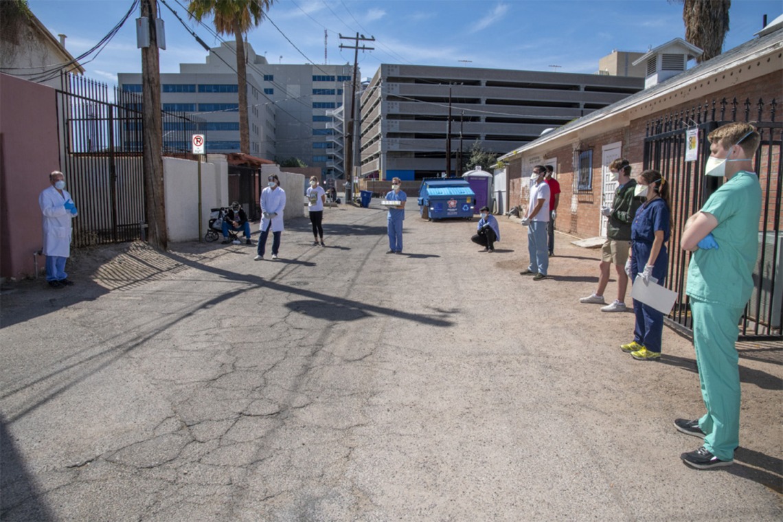 College of Medicine – Tucson students meet downtown before offering health care services to Tucson’s vulnerable homeless population amid the COVID-19 pandemic.
