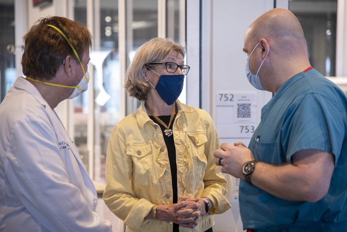 Joe DeBoe, DNP, ACMPC-AG, CCRN, right, talks with  Dean Ida Moore, PhD, RN, FAAN, and David Trinidad, DNP, during the first in-person AGACNP clinical skills intensive to be held at ASTEC since the pandemic. 
