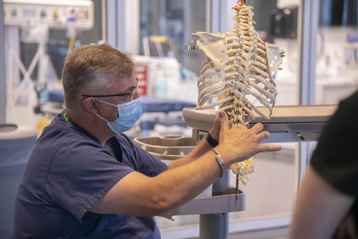 Chris Herring, DNP, CRNA, demonstrates techniques used for a lumbar puncture...  “While CRNA's do not routinely perform this technique for diagnostic reasons, the approach is very similar to the placement of neuraxial blocks which we use for analgesia,” said Dr. Herring.