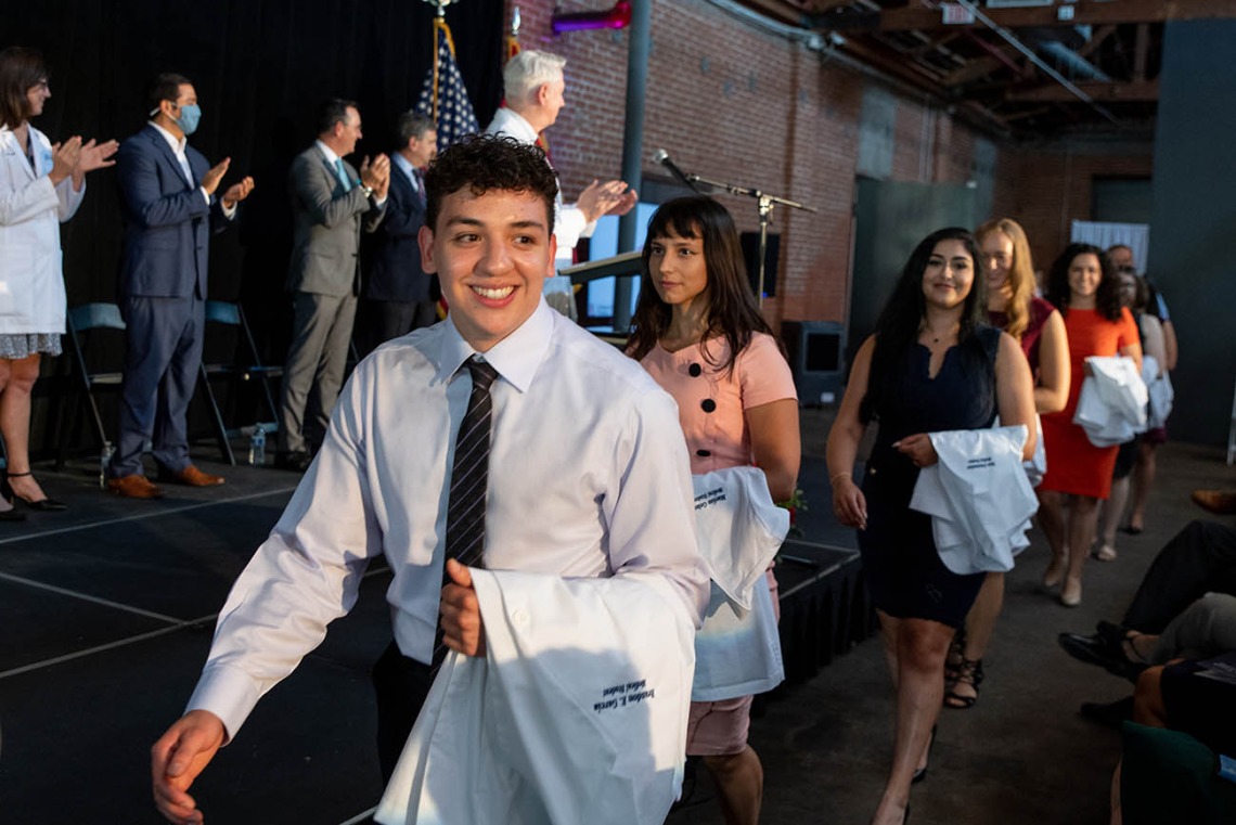 Brandon Garcia, Maëliss Gelas, Tara Ghalambor, Michelle Goforth and Rose Graf pass in front of the stage as they enter the room at the beginning of the ceremony.