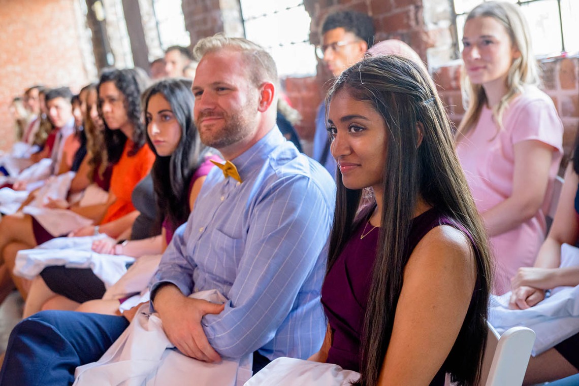Dexter Gulick, Rachna Guntu and other new medical students listen to the speakers during the ceremony.