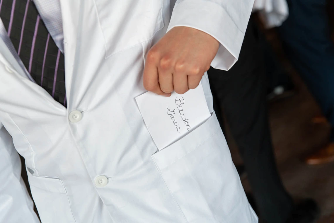 Brandon Garcia discovers a personal note in the pocket of his white coat. The notes are a traditional part of the white coat ceremonies.