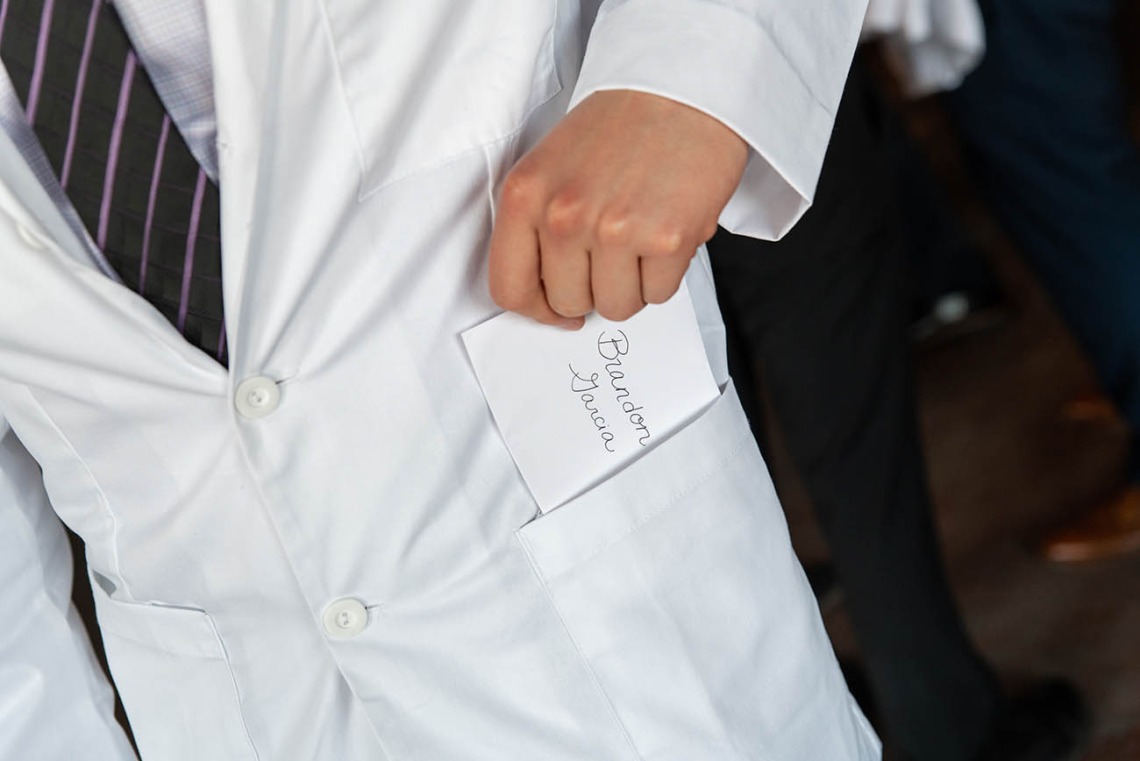 Brandon Garcia discovers a personal note in the pocket of his white coat. The notes are a traditional part of the white coat ceremonies.