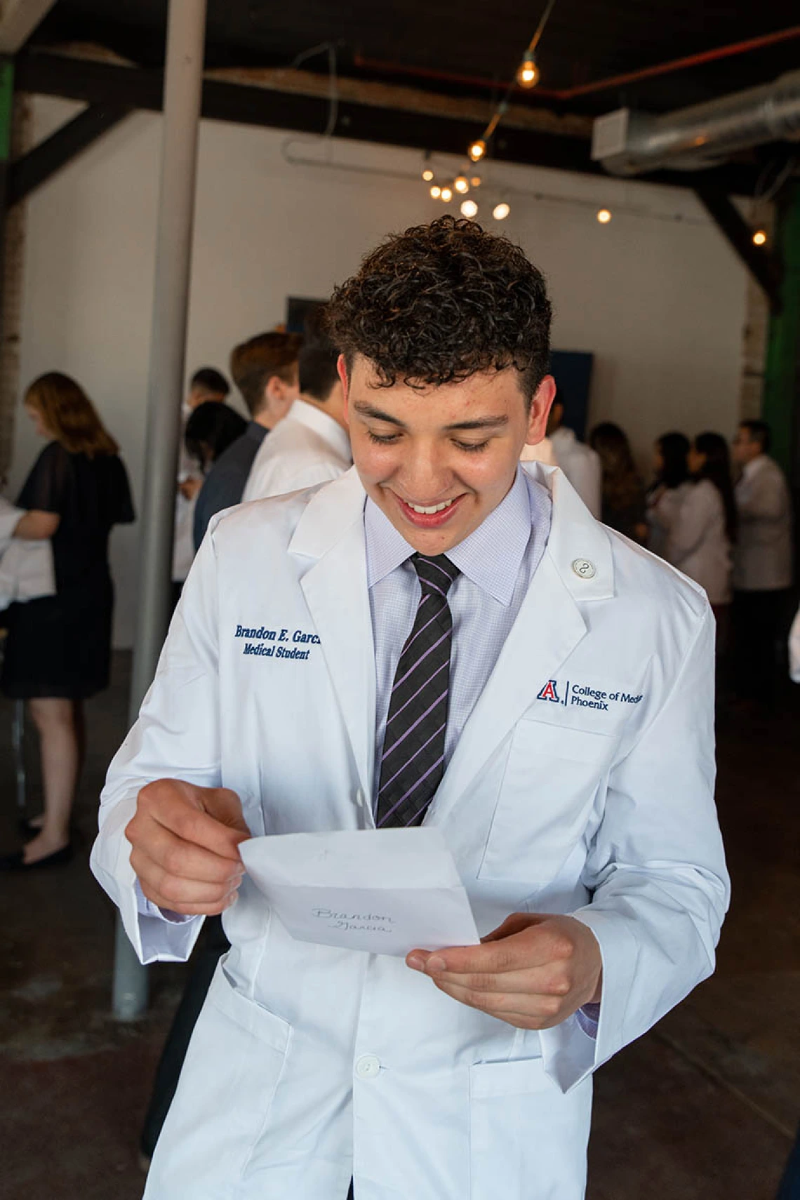 Brandon Garcia reads his personal white coat note.