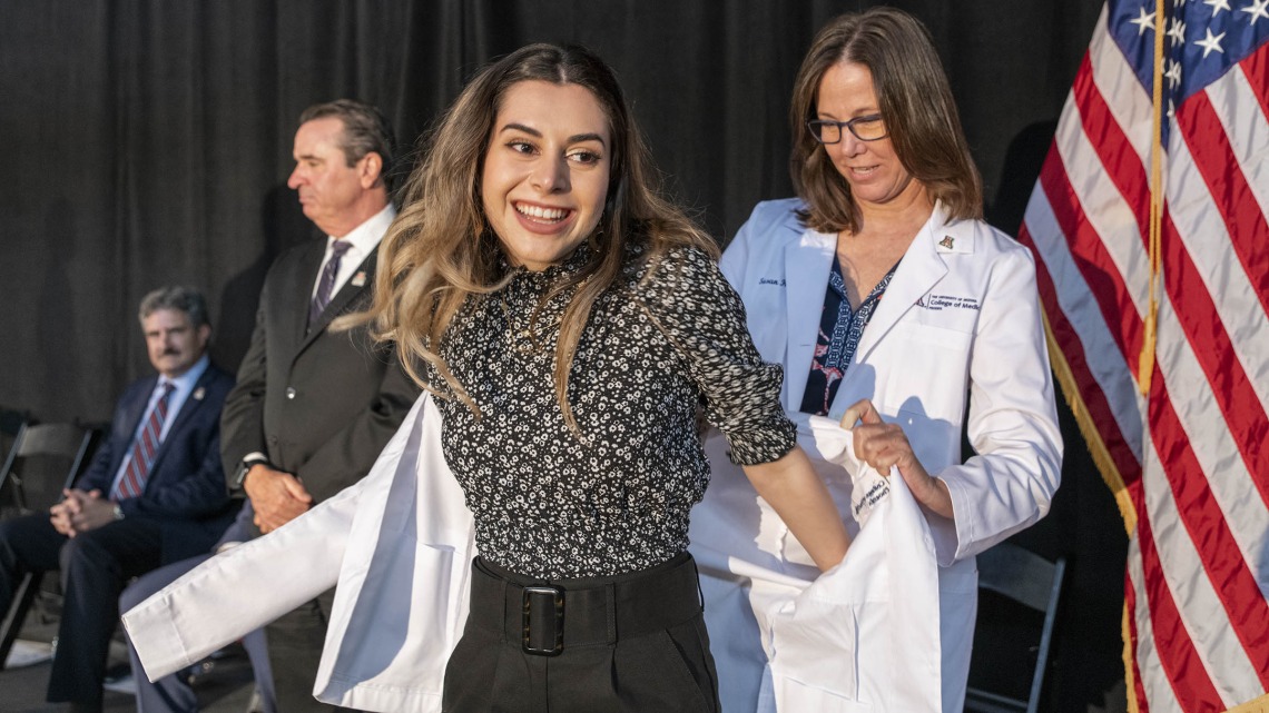 Natalie Nabaty receives her white coat from Susan Kaib, MD, FAAFP, at the class of 2025 University of Arizona College of Medicine – Phoenix white coat ceremony.