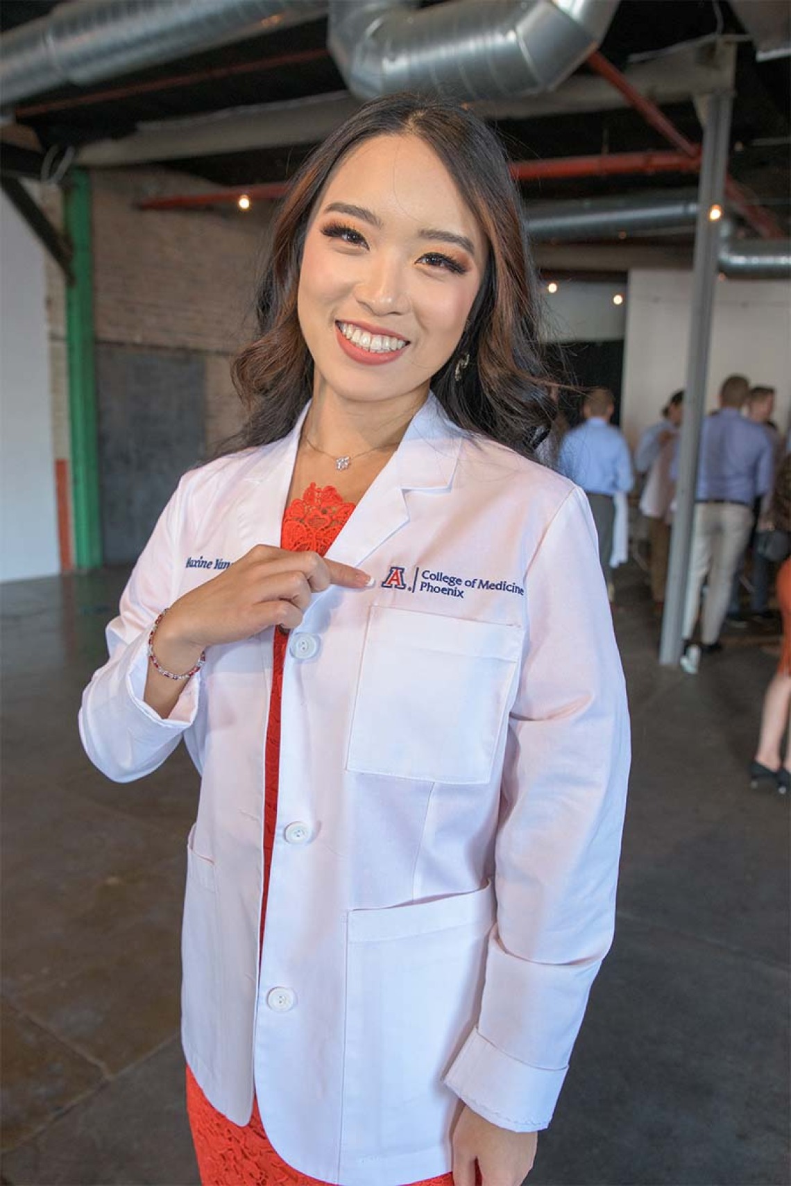 Maxine Yang proudly shows off her UArizona College of Medicine – Phoenix white coat before the ceremony.