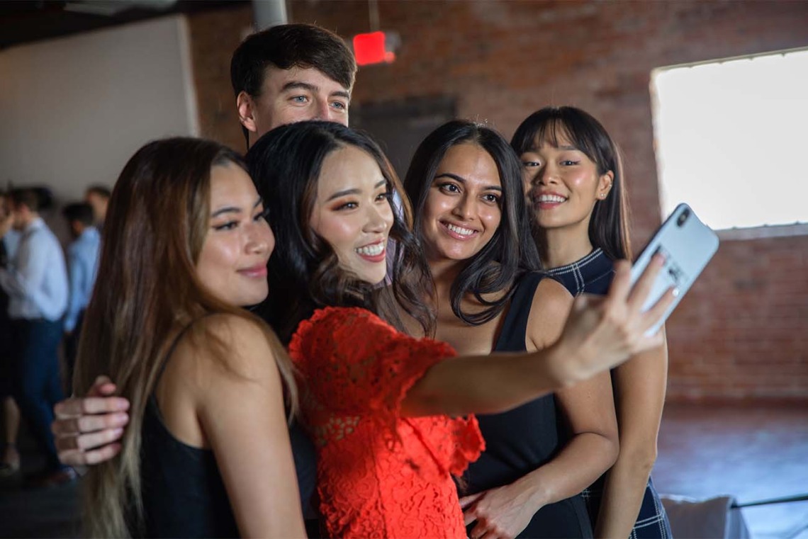 From left, Theresa Bui, Maxine Yang, Vrishti Shah, Yerina Cho and Trevor Smith (back) take a selfie-for-five after the white coat ceremony.