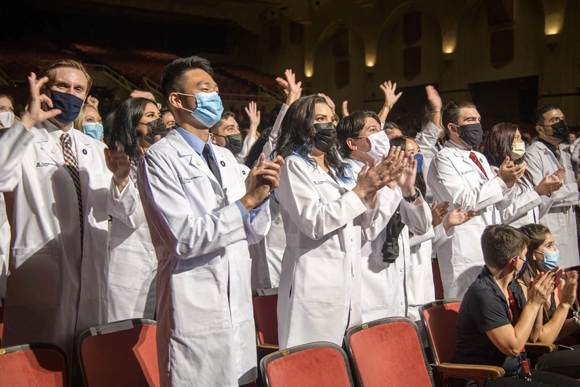 Class of 2025 medical students applaud at the end of their white coat ceremony.