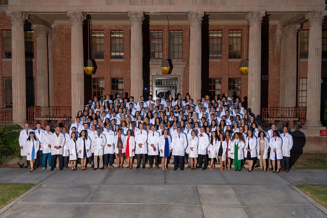 UArizona College of Medicine – Tucson Class of 2025 faculty and staff gather for a group photo in front of Cochise Hall after the white coat ceremony.