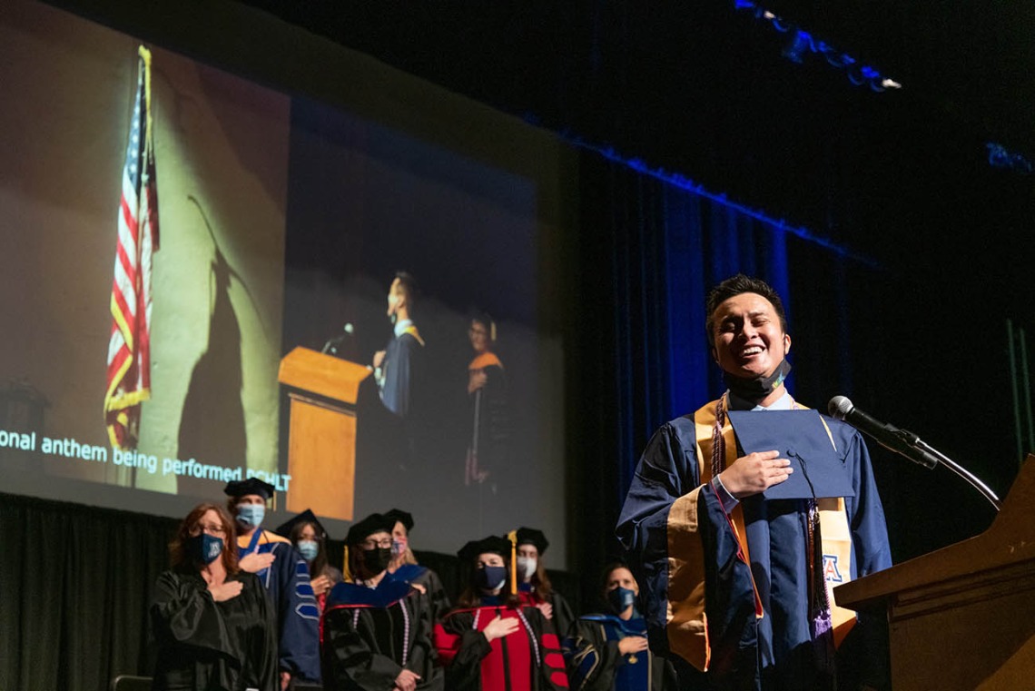 Kevin Vidal sings the National Anthem during the College of Nursing’s August commencement at Centennial Hall.