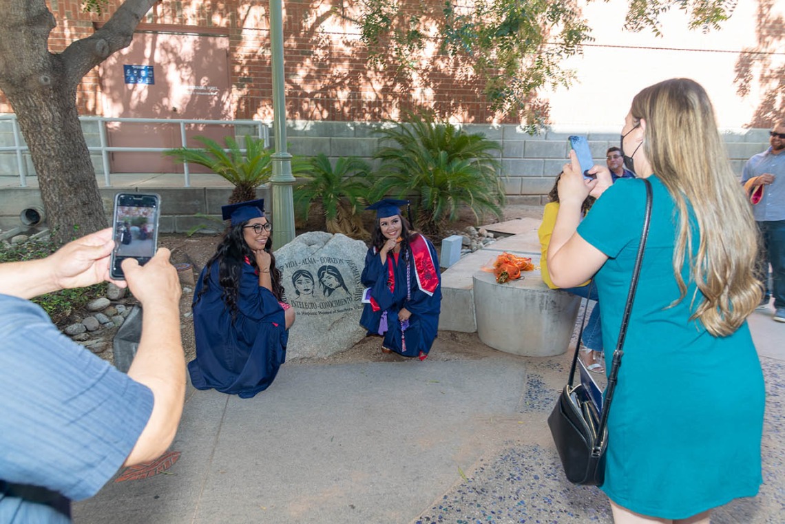 Rita Morado (left) and Valeria Pena-Quijada pose for a photo after the August commencement.
