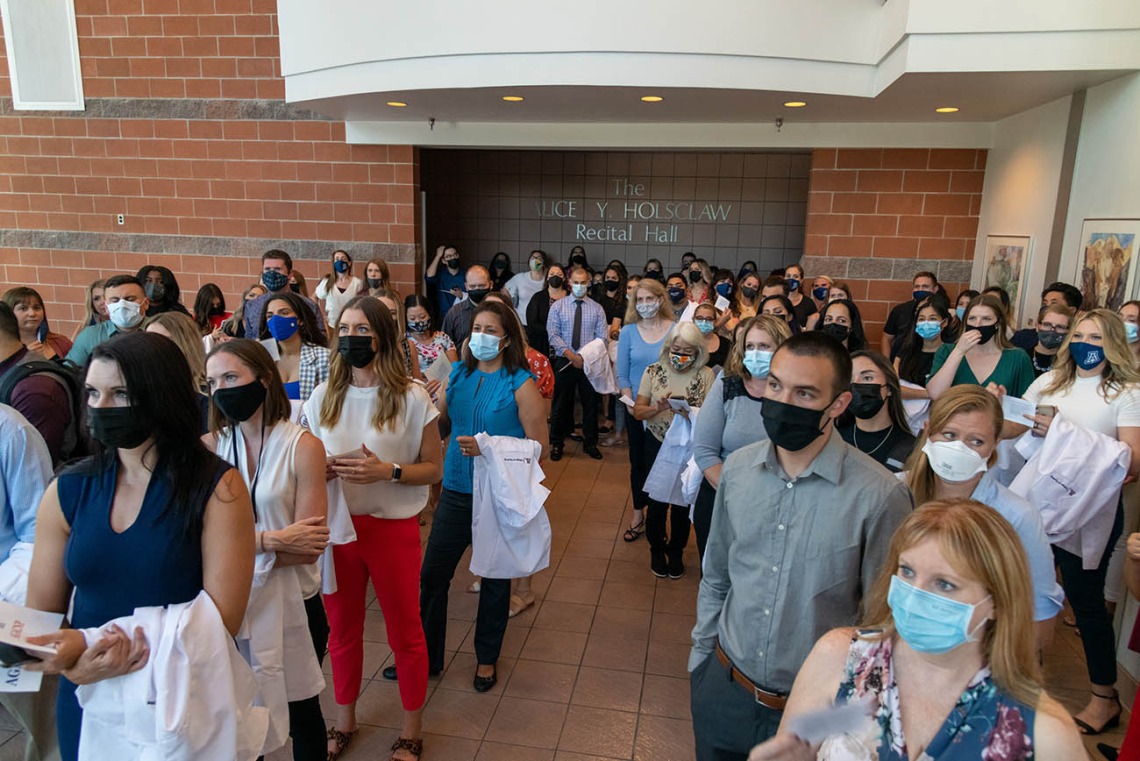 Doctor of Nursing Practice students wait to enter Crowder Hall for their white coat ceremony. 
