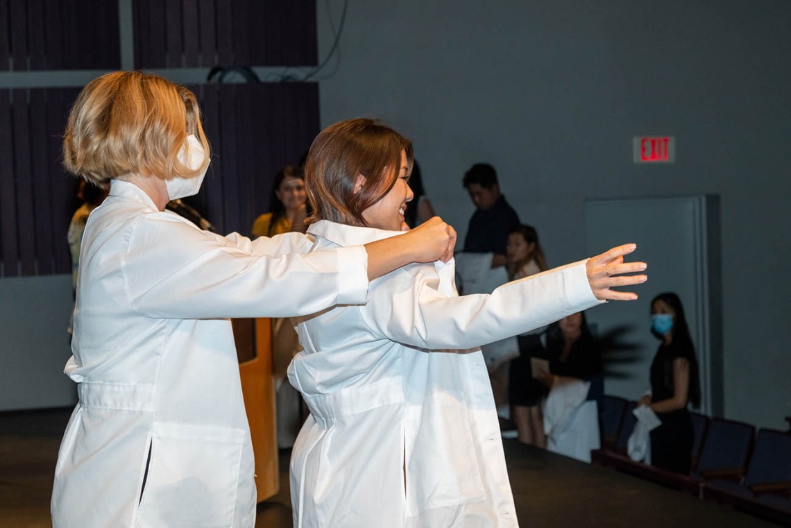 Doctor of Nursing Practice student Sherry Nguyen is presented with her white coat at the ceremony. 