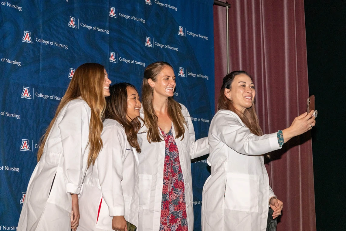 Doctor of Nursing Practice students (from left) Tyra Hepworth, Paige Nyland, Stephanie Gasser and Cynthia Hill take a selfie after the white coat ceremony. 