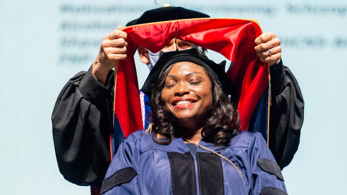 Christiana Billedalley, who completed her Doctor of Nursing Practice degree, is hooded during the College of Nursing convocation in December at Centennial Hall.