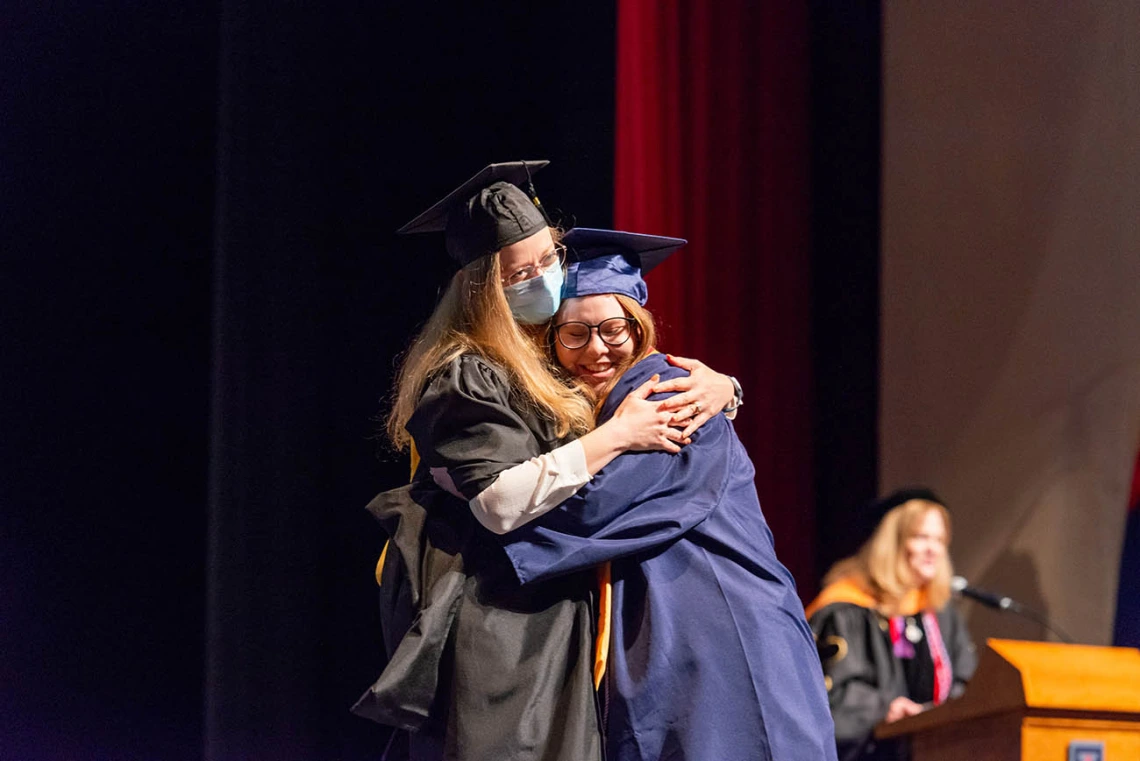 Christine Windes hugs her presenter after receiving her Bachelor of Science in Nursing during the College of Nursing fall convocation.