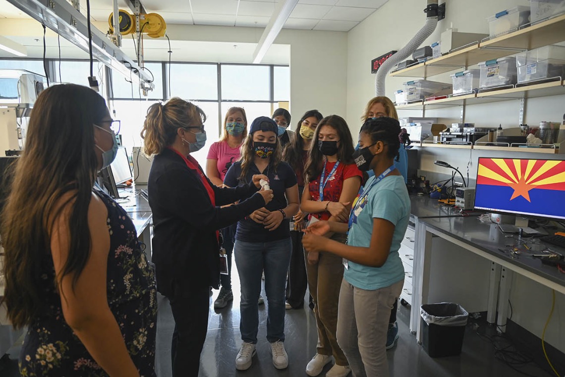 Deana Ann Smith, RN, health care simulation educator for ASTEC (second from left), takes  middle school girls from the ACES camp on a tour of the tissue lab. 